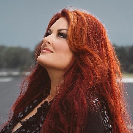Judd's mother Wynonna with her long and red hair.